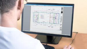 User at a computer utilizing the OnScreen Takeoff software from OnCenter software by ConstructConnect